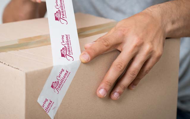 Caring Transitions branded packing tape and box